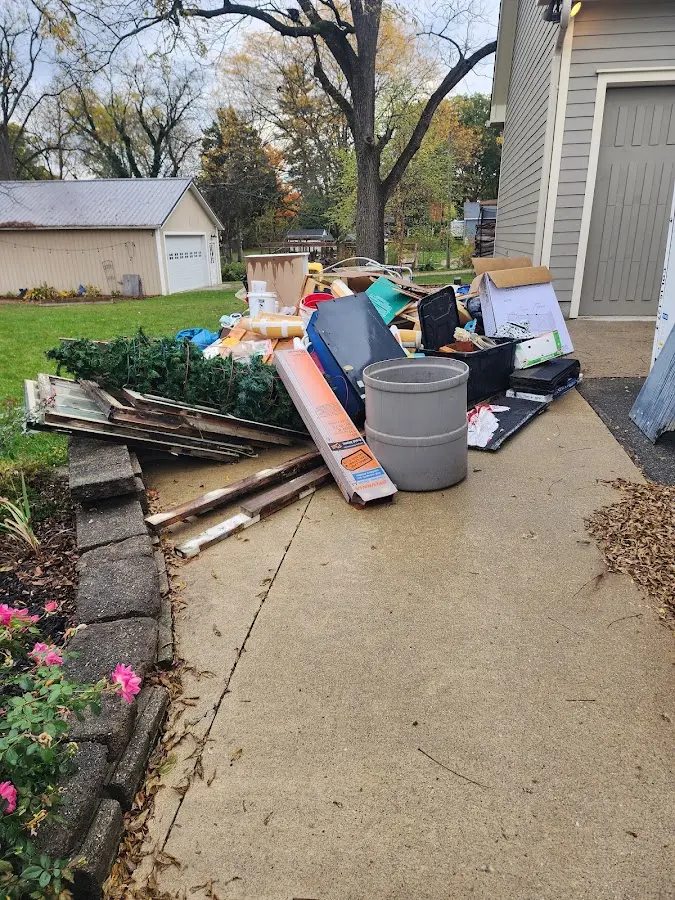 Dumpster being loaded with debris for Demolition Dumpster Rental in Creve Coeur